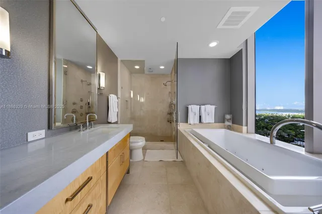 a large hall with stainless steel appliances granite countertop a sink and cabinets