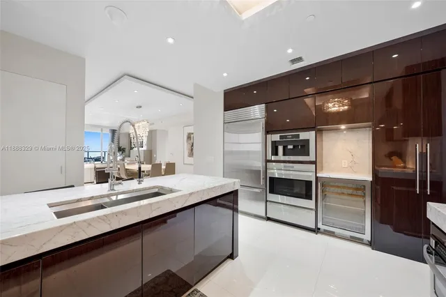 a kitchen with stainless steel appliances kitchen island granite countertop a sink and a stove