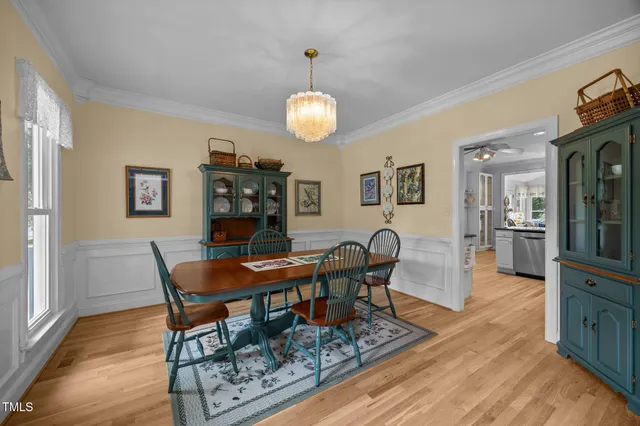 a view of a dining room with furniture wooden floor and chandelier