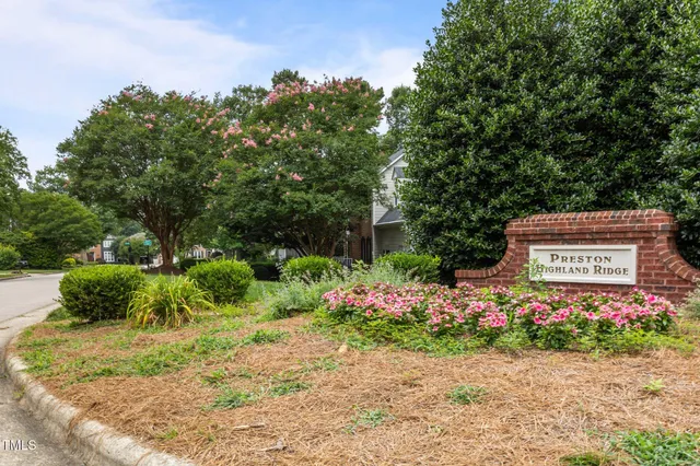 a sign that is sitting in front of flowers