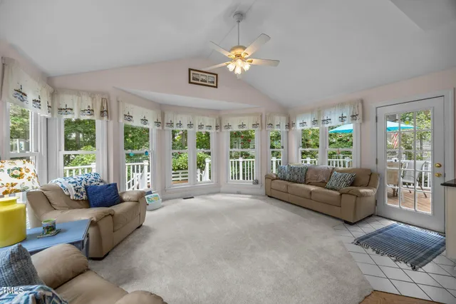 a living room with furniture and large windows