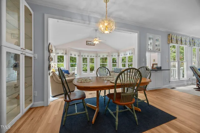 a view of a dining room with furniture wooden floor and chandelier