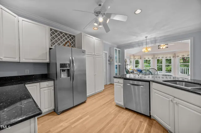 a kitchen with granite countertop a refrigerator and a sink