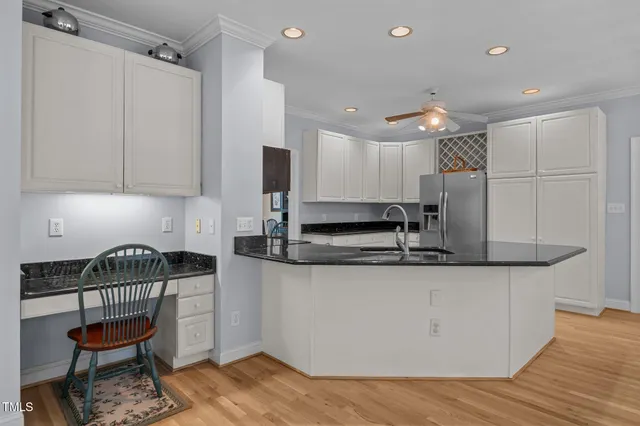 a kitchen with stainless steel appliances granite countertop a sink a stove a refrigerator and a microwave