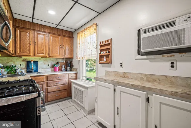 a kitchen with stainless steel appliances a stove microwave and sink