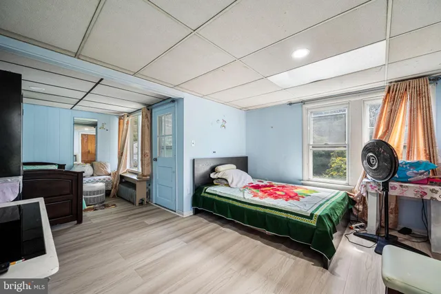 a living room with furniture flat screen tv and a large window