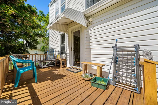 a view of a backyard with plants and a bench