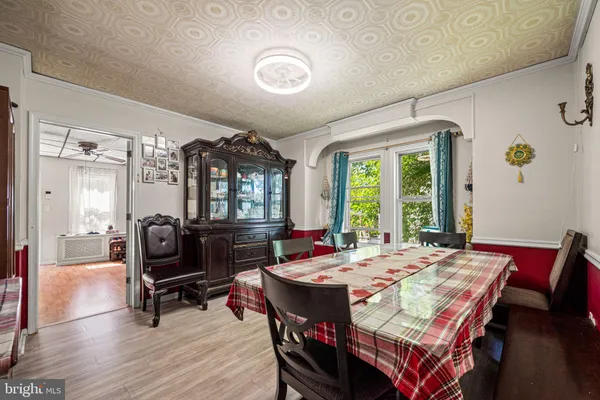 a dining room with a wooden table and chairs
