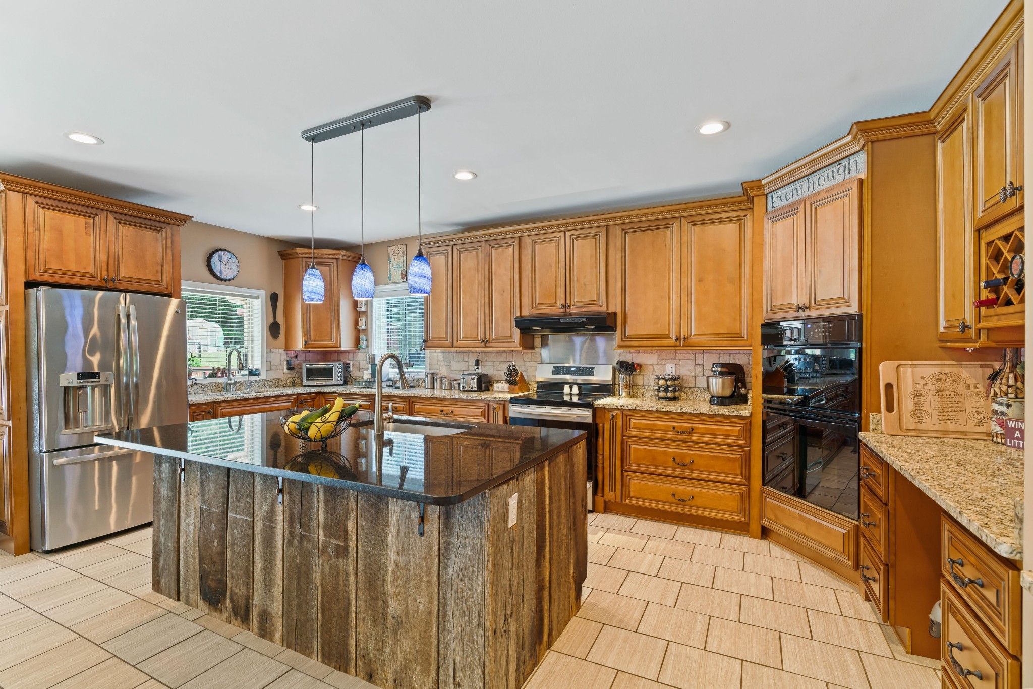 725 Fowler Ford Road Portland, TN 37148 - Photo 12 of 66 a kitchen with granite countertop a refrigerator stove top oven dining table and chairs
