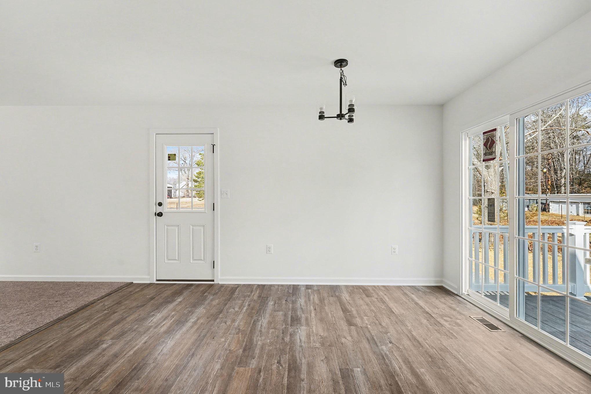 6285 Waterford Road Rixeyville, VA 22737 - Photo 19 of 36 an empty room with wooden floor and windows