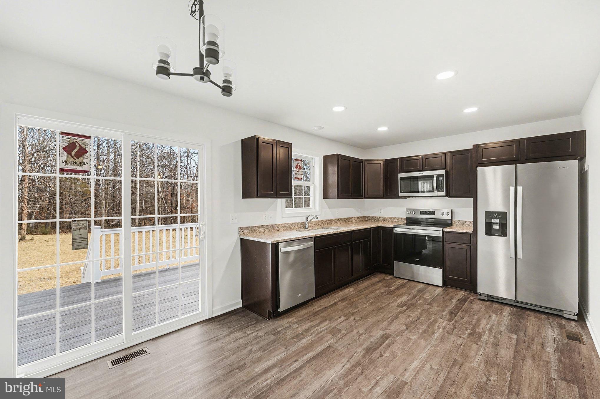 6285 Waterford Road Rixeyville, VA 22737 - Photo 2 of 36 a large kitchen with kitchen island granite countertop a refrigerator stove top oven and sink
