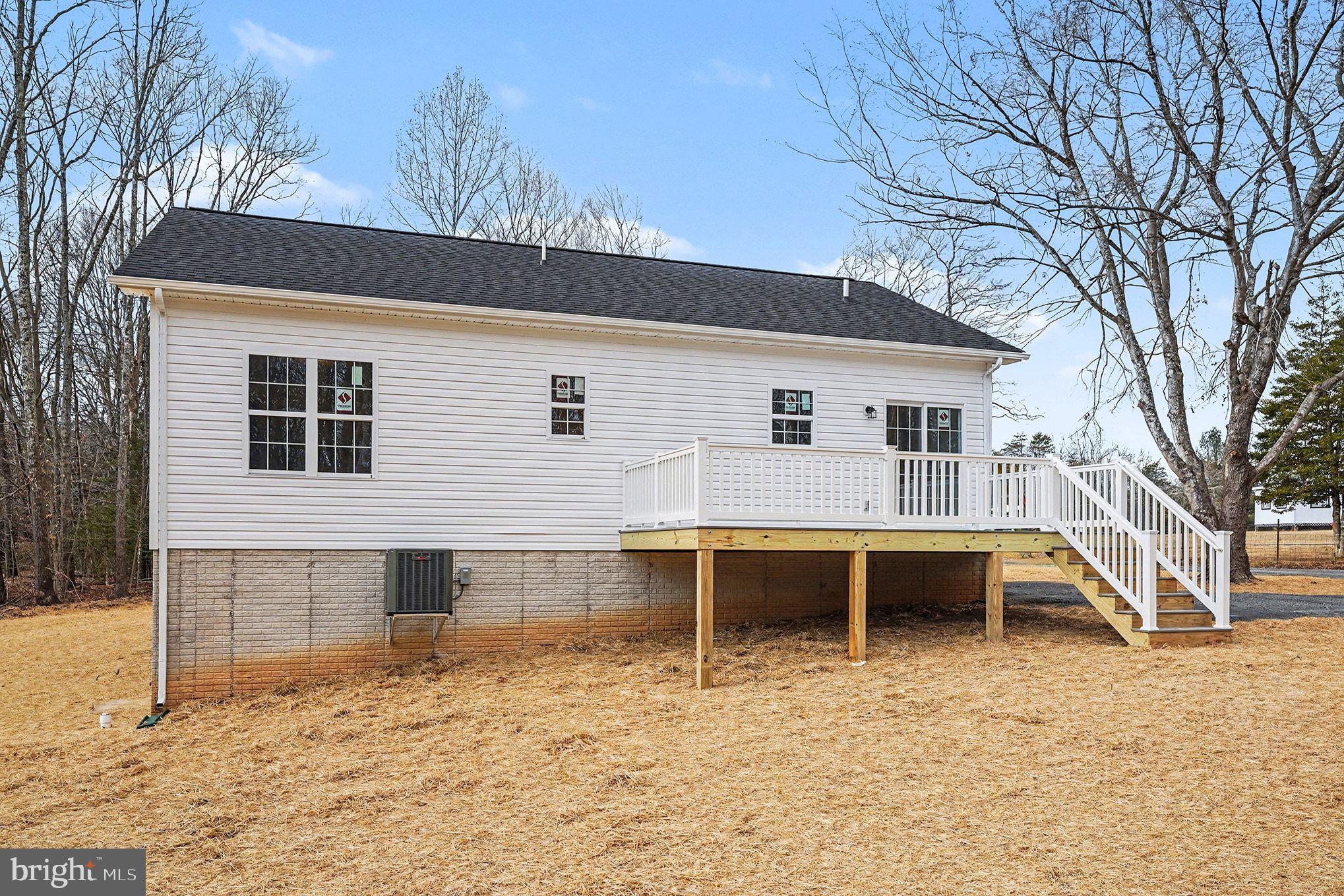 6285 Waterford Road Rixeyville, VA 22737 - Photo 35 of 36 a view of a white house with a large pool and a lawn chairs under wooden roof