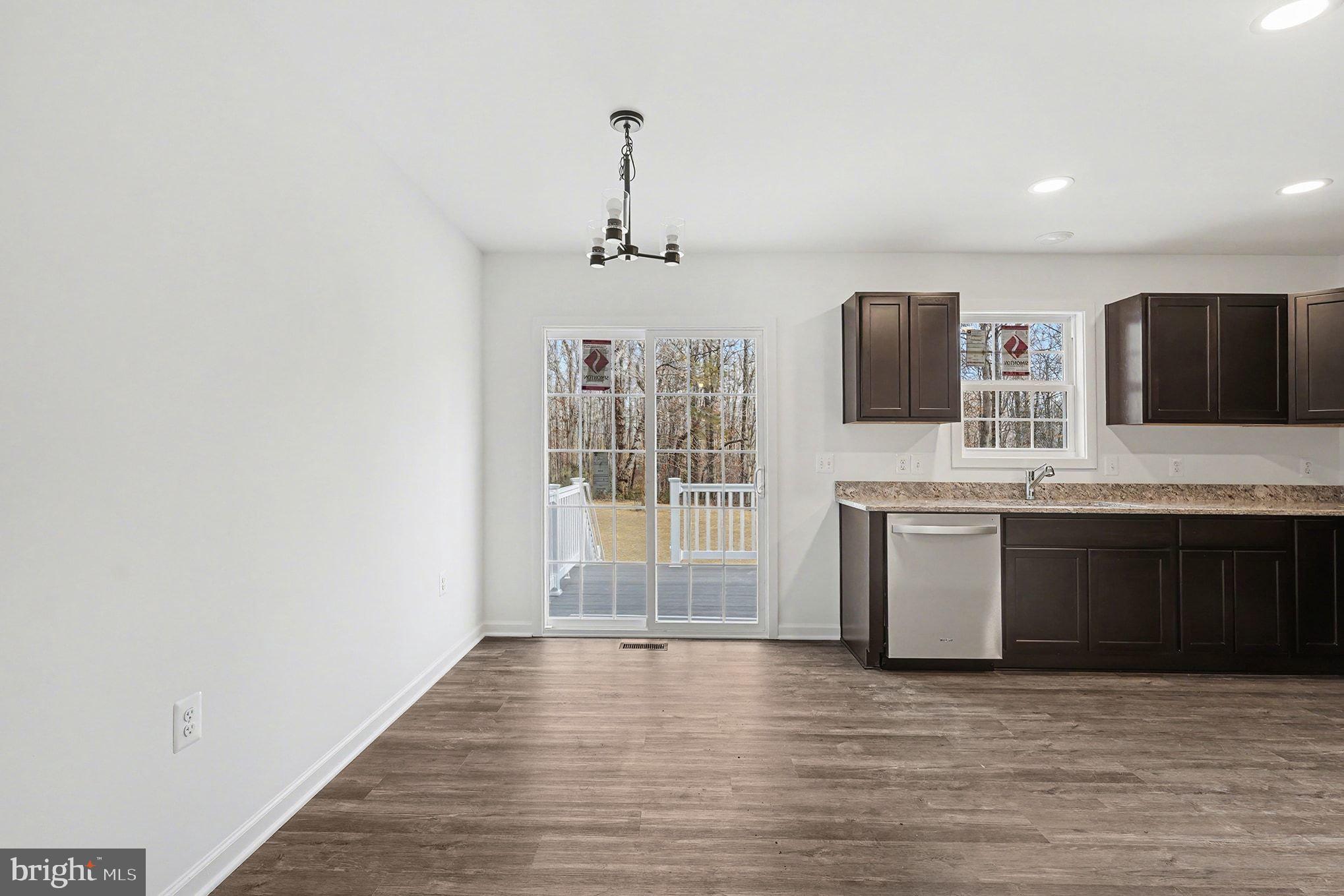 6285 Waterford Road Rixeyville, VA 22737 - Photo 6 of 36 a view of a kitchen with a sink wooden cabinets and a window