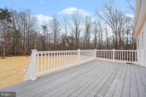a view of balcony with wooden floor and fence