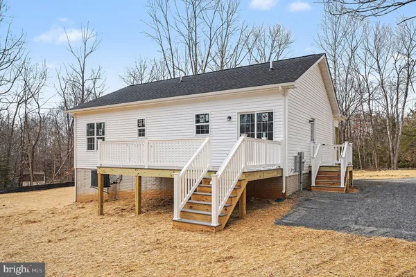 a view of a house with a yard and roof deck