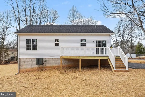 a view of a house with a wooden fence