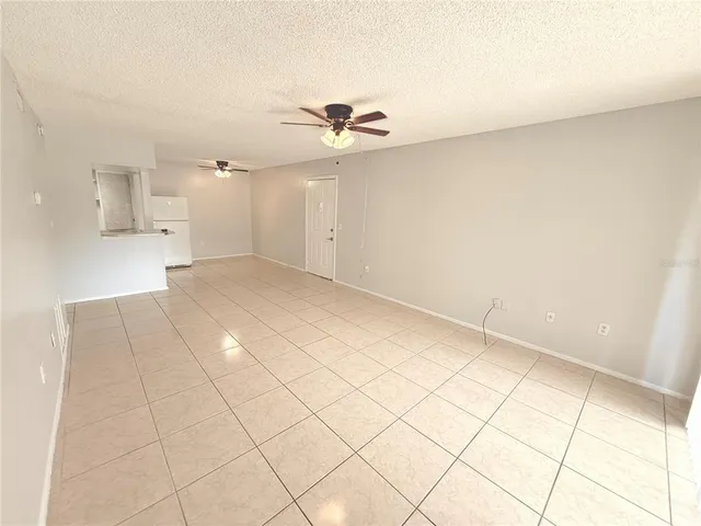an empty room with closet and fan