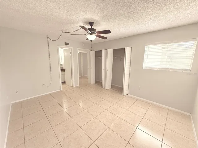 an empty room with fan and fan