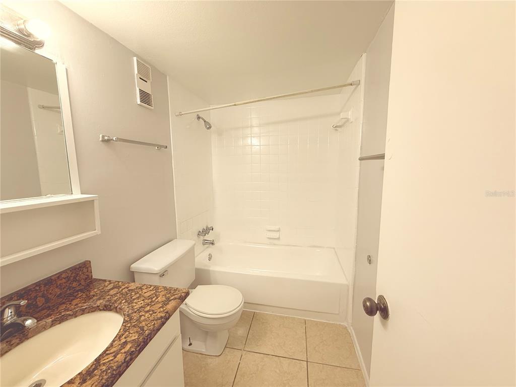 910 Lake Destiny Road, Unit E Altamonte Springs, FL 32714 - Photo 7 of 29 a bathroom with a granite countertop sink toilet and shower