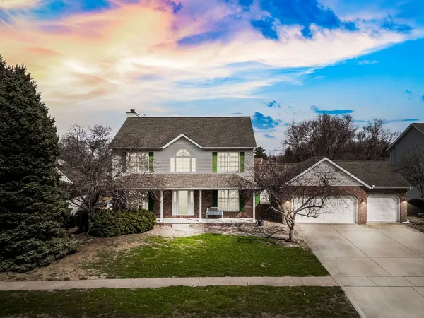 a view of a house with backyard and deck