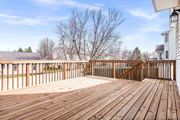 a balcony with wooden floor and fence