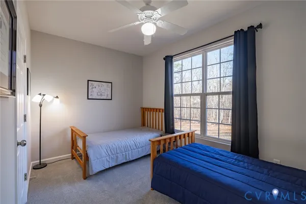 a bedroom with furniture and wooden floor