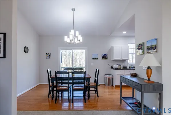 a view of a dining room with furniture and chandelier