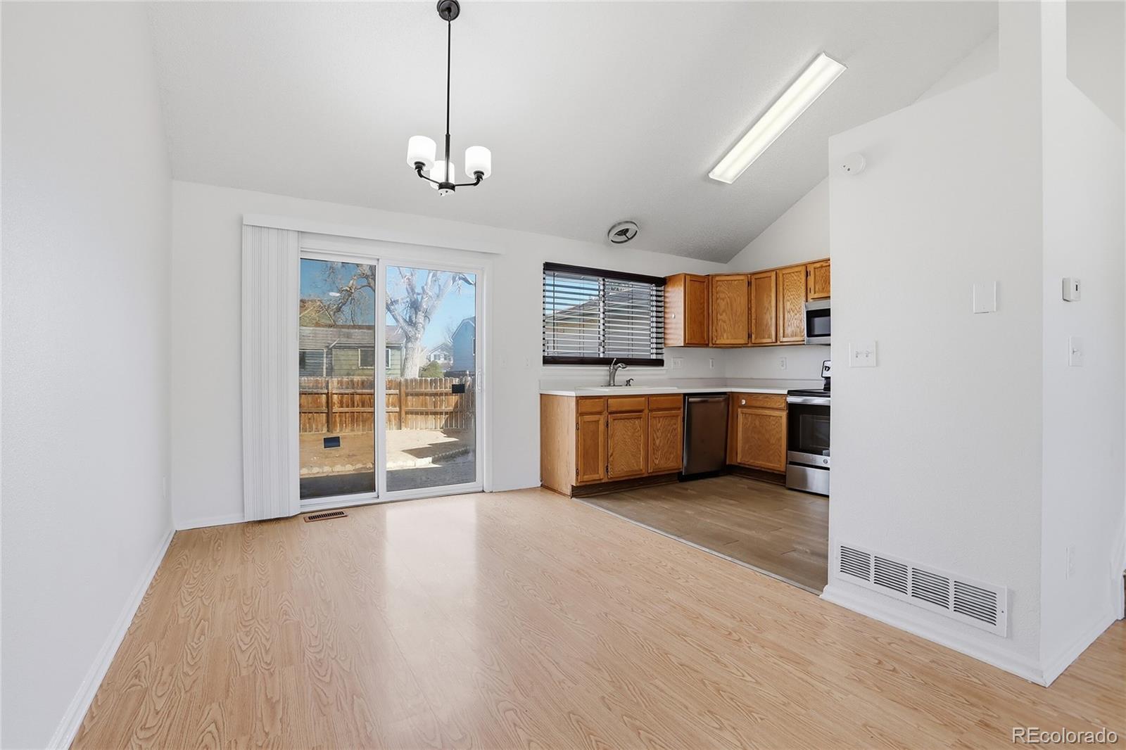 4381 Perth Circle Denver, CO 80249 - Photo 13 of 35 a view of a kitchen with a sink cabinets and a living room