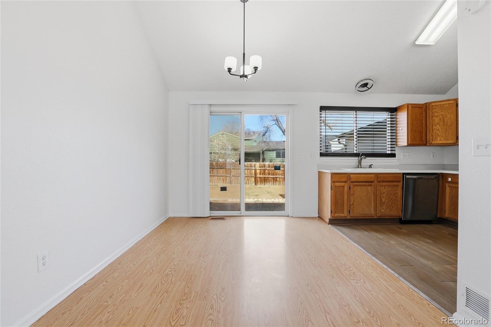 4381 Perth Circle Denver, CO 80249 - Photo 14 of 35 a view of a kitchen with a sink and dishwasher wooden floor