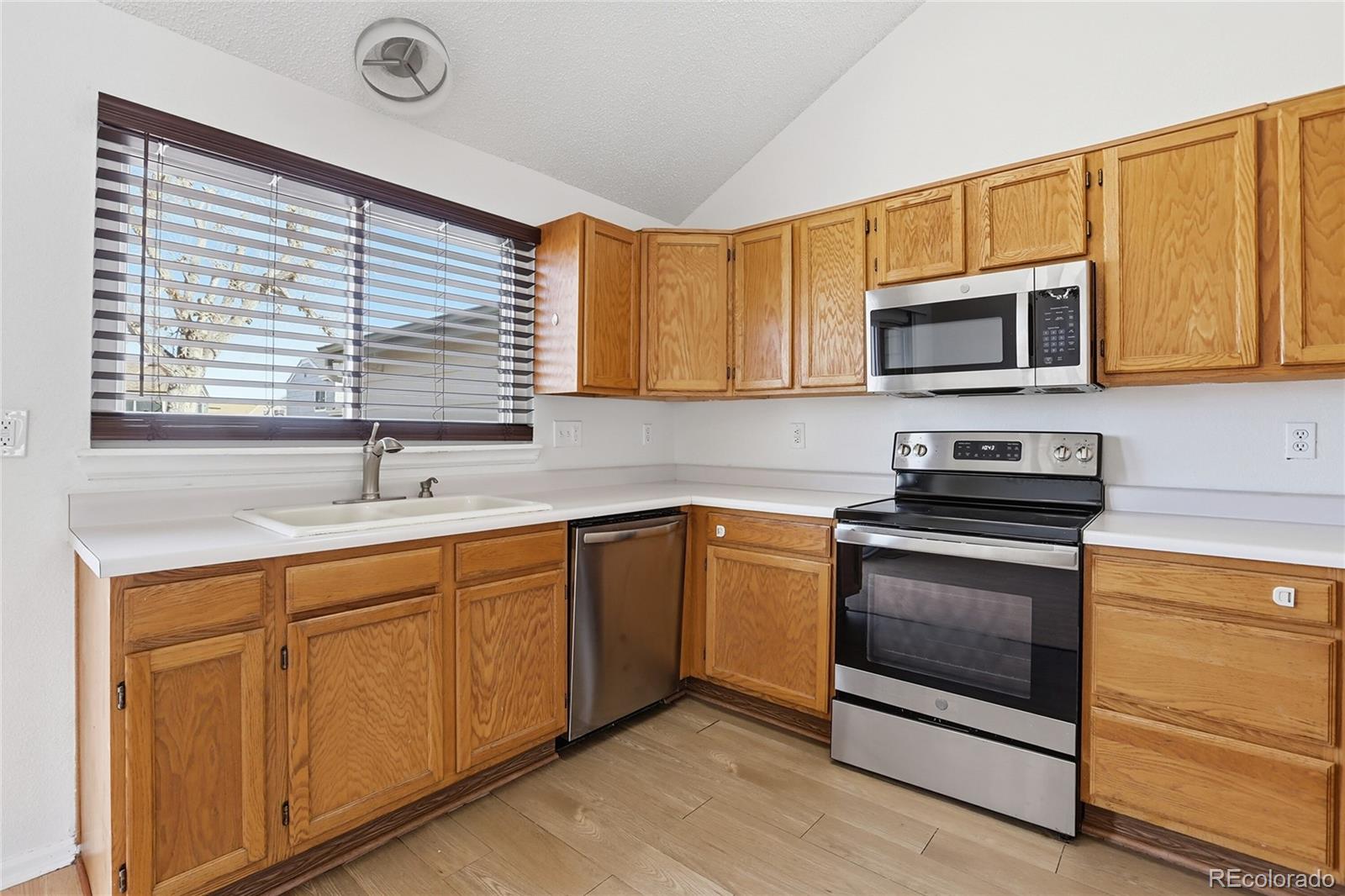 4381 Perth Circle Denver, CO 80249 - Photo 15 of 35 a kitchen with stainless steel appliances granite countertop a sink and a microwave