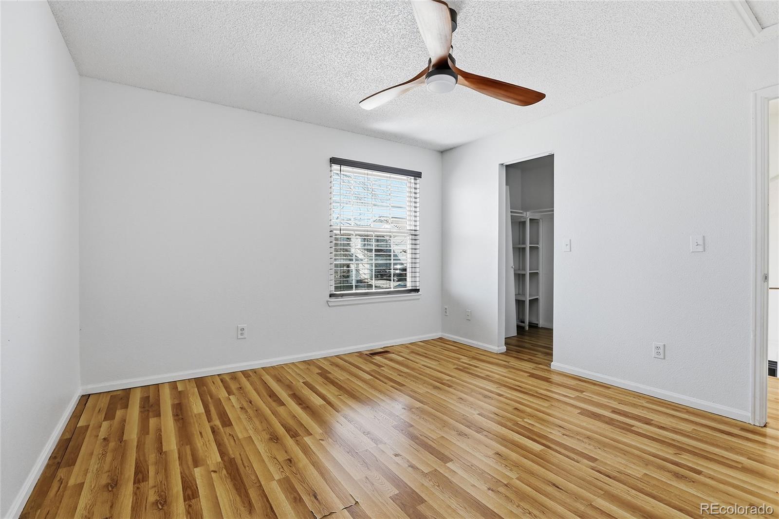 4381 Perth Circle Denver, CO 80249 - Photo 16 of 35 a view of empty room with wooden floor and fan