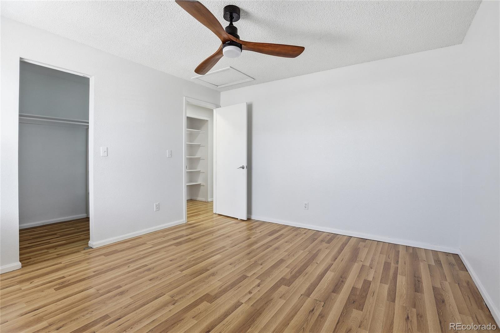 4381 Perth Circle Denver, CO 80249 - Photo 17 of 35 a view of empty room with wooden floor
