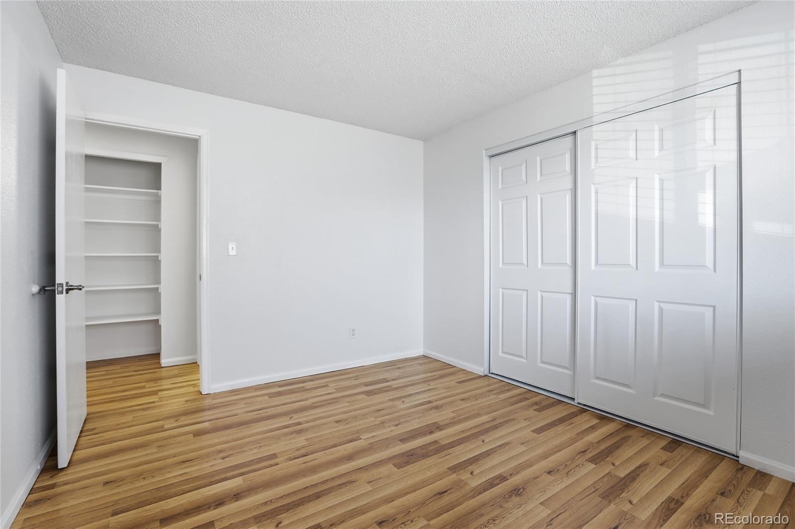 4381 Perth Circle Denver, CO 80249 - Photo 18 of 35 a view of empty room with wooden floor and entryway