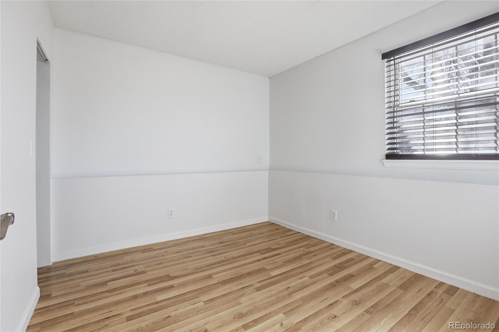 4381 Perth Circle Denver, CO 80249 - Photo 20 of 35 a view of a room with wooden floor and windows