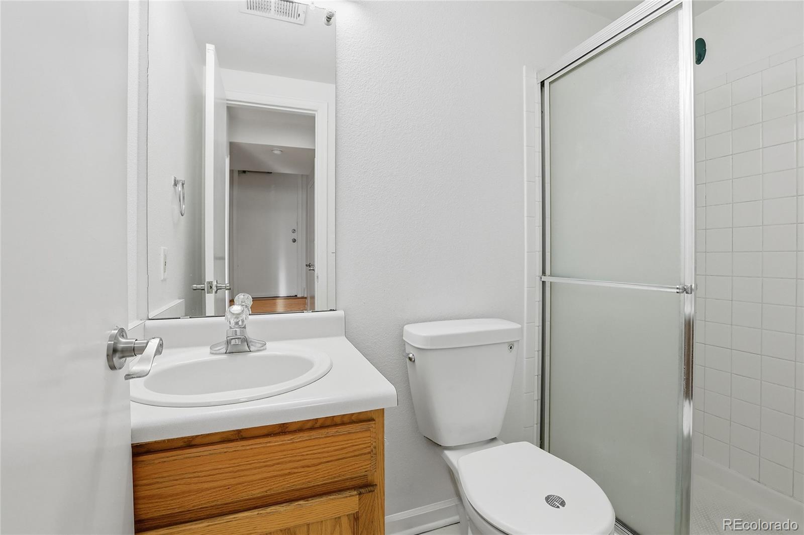 4381 Perth Circle Denver, CO 80249 - Photo 22 of 35 a bathroom with a sink a toilet and shower