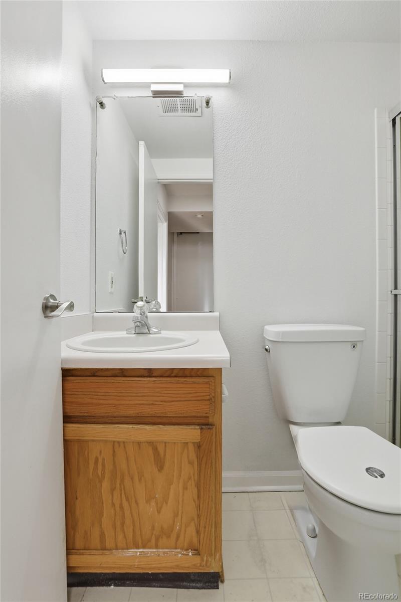 4381 Perth Circle Denver, CO 80249 - Photo 23 of 35 a bathroom with a toilet a sink and mirror