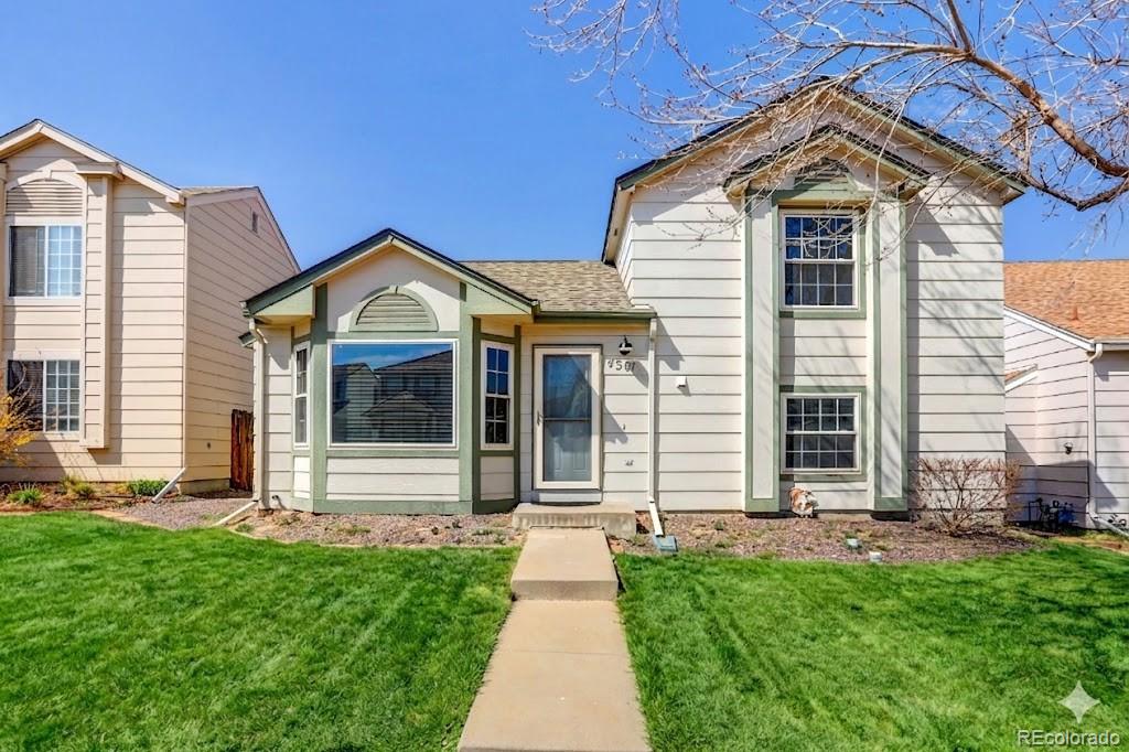 4381 Perth Circle Denver, CO 80249 - Photo 26 of 35 a front view of a house with a yard