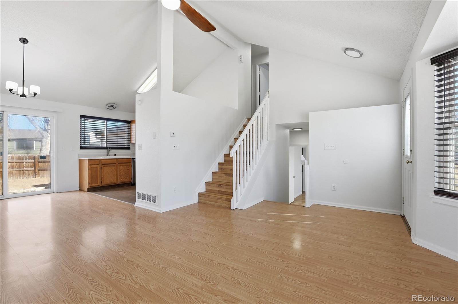 4381 Perth Circle Denver, CO 80249 - Photo 3 of 35 a view of a livingroom with wooden floor and stairs