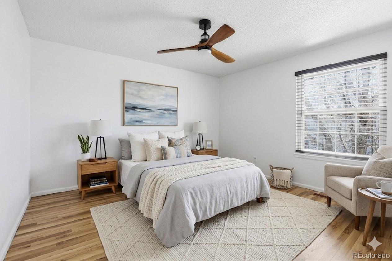 4381 Perth Circle Denver, CO 80249 - Photo 7 of 35 a bedroom with a bed and wooden floor