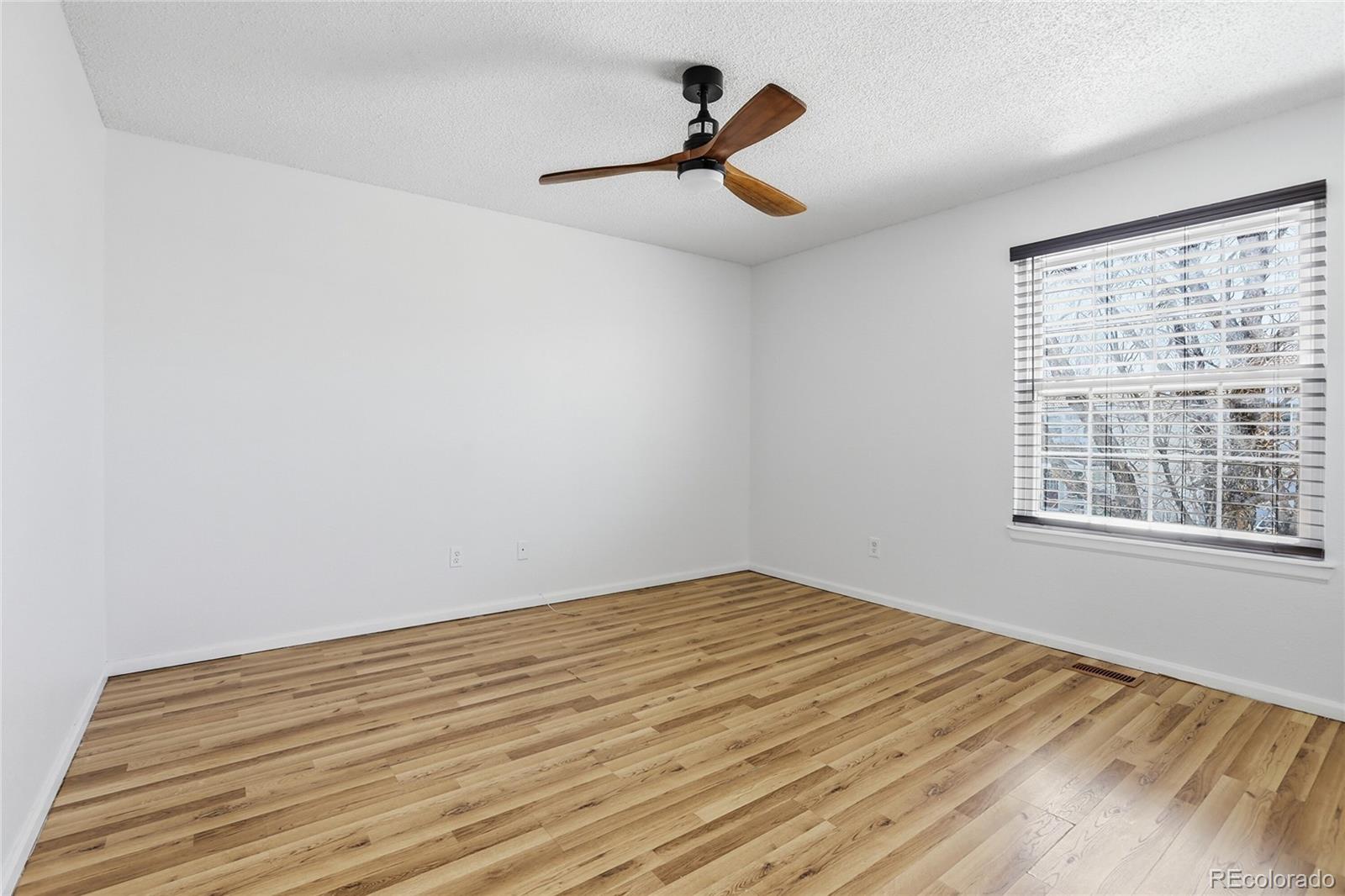 4381 Perth Circle Denver, CO 80249 - Photo 8 of 35 a view of a room with a wooden floor and a window