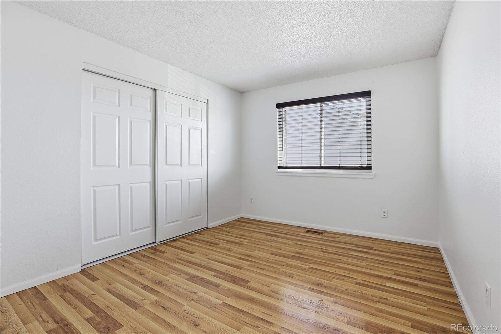 4381 Perth Circle Denver, CO 80249 - Photo 10 of 35 a view of empty room with wooden floor and fan