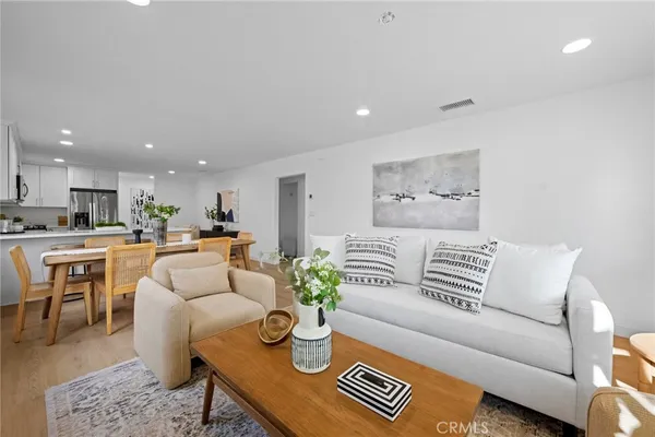 a living room with furniture and kitchen view