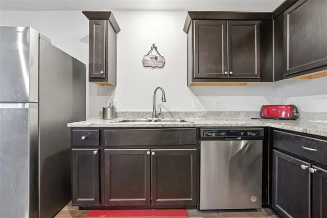 a kitchen with stainless steel appliances granite countertop a sink and cabinets