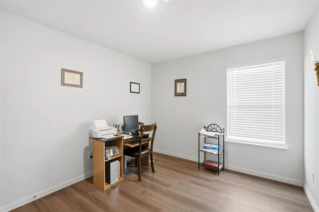 a view of a workspace with furniture and a window