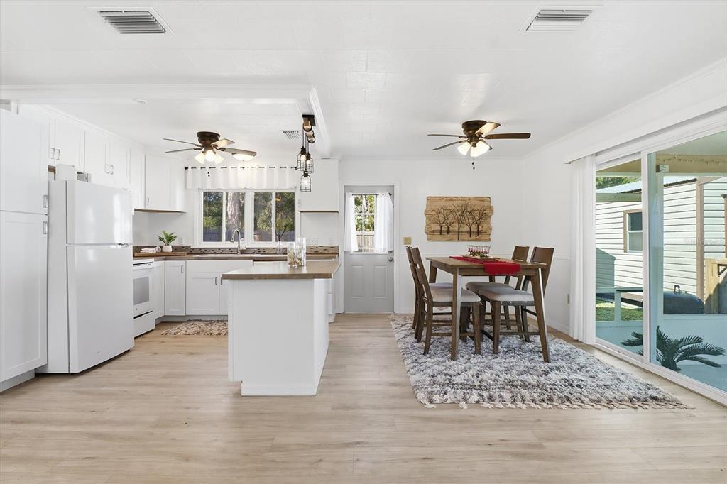 1050 North Midiron Point Crystal River, FL 34429 - Photo 11 of 57 a kitchen with stainless steel appliances kitchen island granite countertop a table chairs sink and cabinets