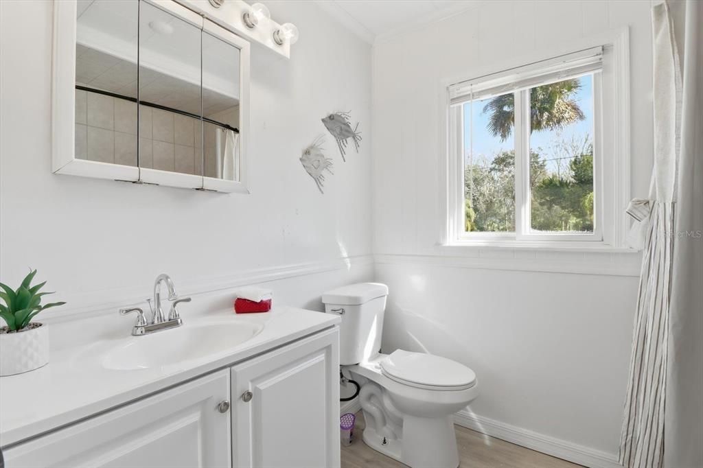 1050 North Midiron Point Crystal River, FL 34429 - Photo 23 of 57 a bathroom with a sink a toilet and a window