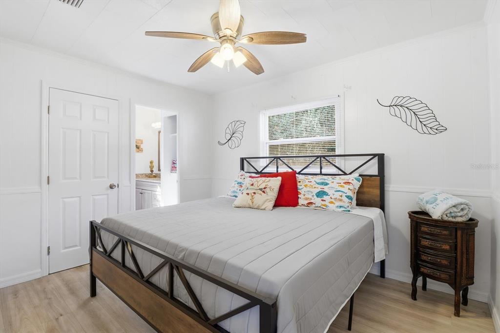 1050 North Midiron Point Crystal River, FL 34429 - Photo 25 of 57 a bedroom with a bed and a chandelier