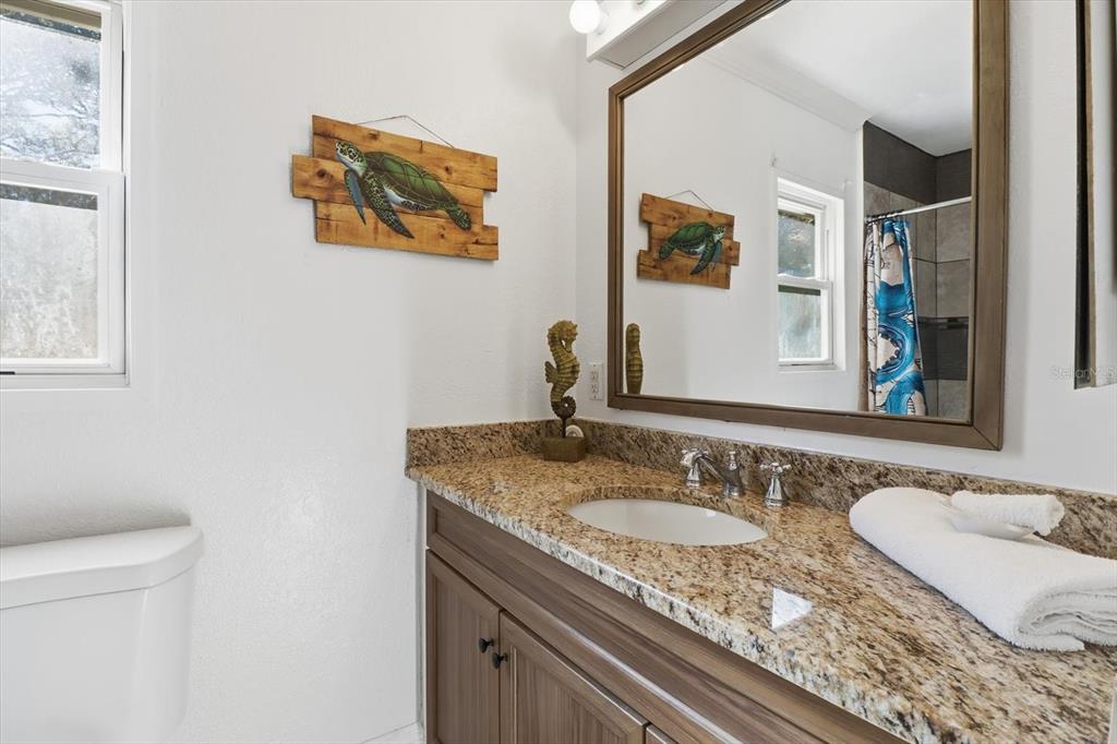 1050 North Midiron Point Crystal River, FL 34429 - Photo 27 of 57 a bathroom with a granite countertop sink and a mirror