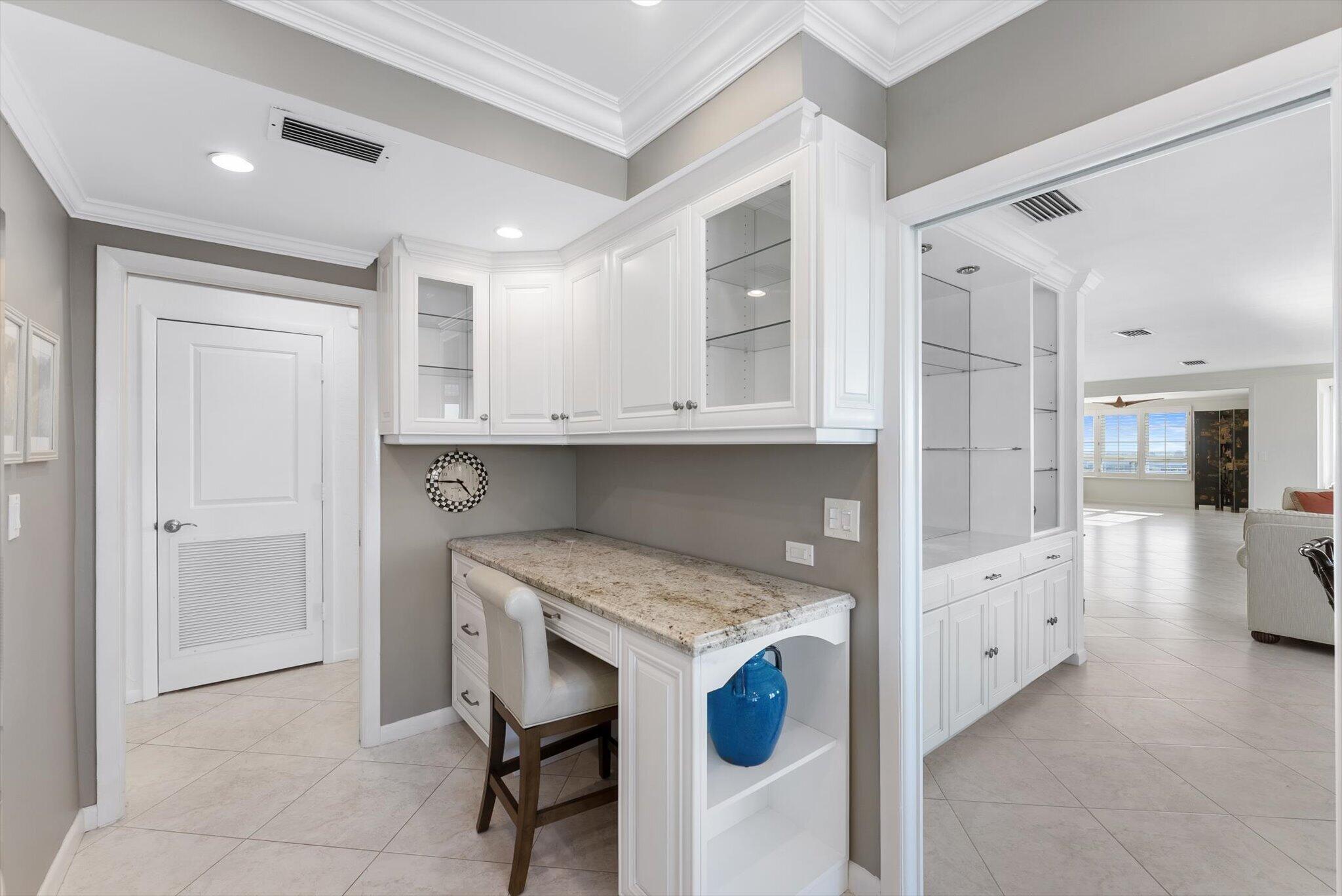 50 E Road, Unit 12A Delray Beach, FL 33483 - Photo 20 of 47 a kitchen with white cabinets and sink