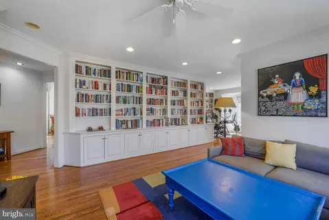 a living room with furniture and a book shelf